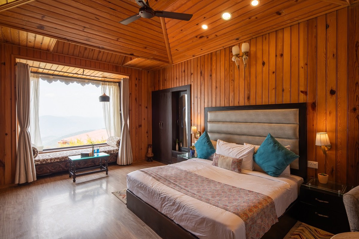 Himalayan Suite at Ojaswi Resort Mukteshwar, featuring traditional wooden interiors and stunning mountain views.