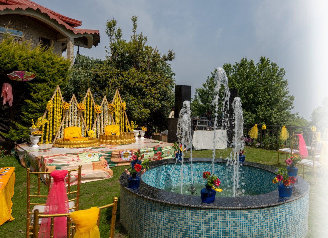 Vibrant Haldi ceremony setup at Ojaswi Resort with traditional yellow decor and a scenic Himalayan backdrop.